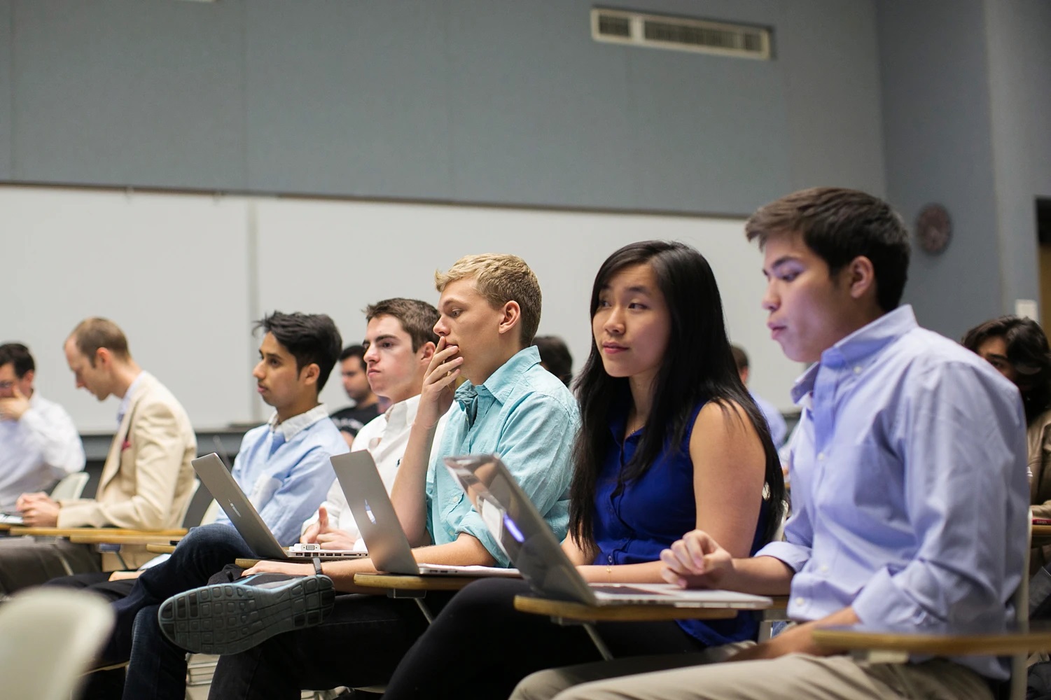 Two students, one female in focus, one male out of shot