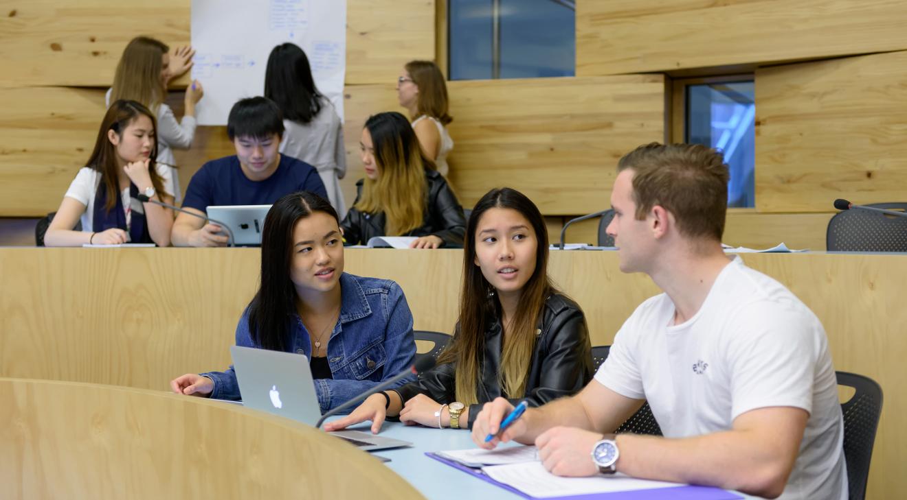 CUA Business students collaborating in Oval Classroom