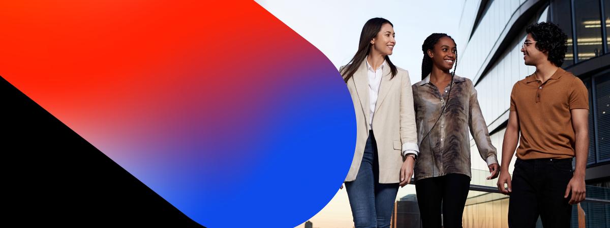 Three CUA students stand in front of a building featuring a striking red and blue colour scheme.