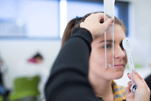 CUA Orthoptics student testing eyesight