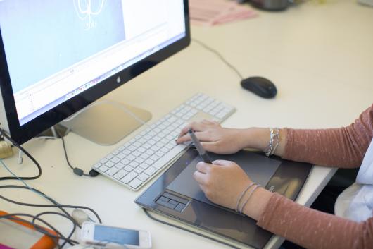 Design student at computer desk