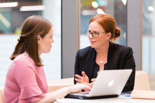 Two people at sitting having a discussion