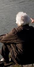 Elderly couple sitting by the water