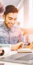 student smiling and working