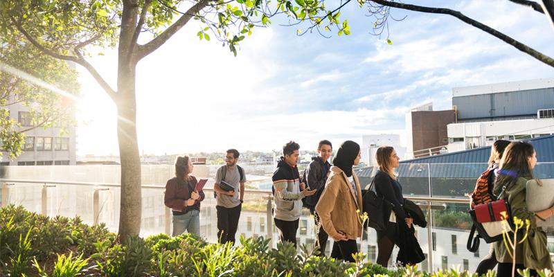 Photo of students walking on balcony